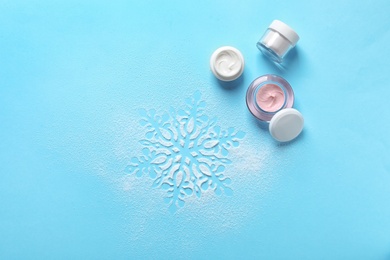 Photo of Set of cosmetic products on blue background, flat lay. Winter care