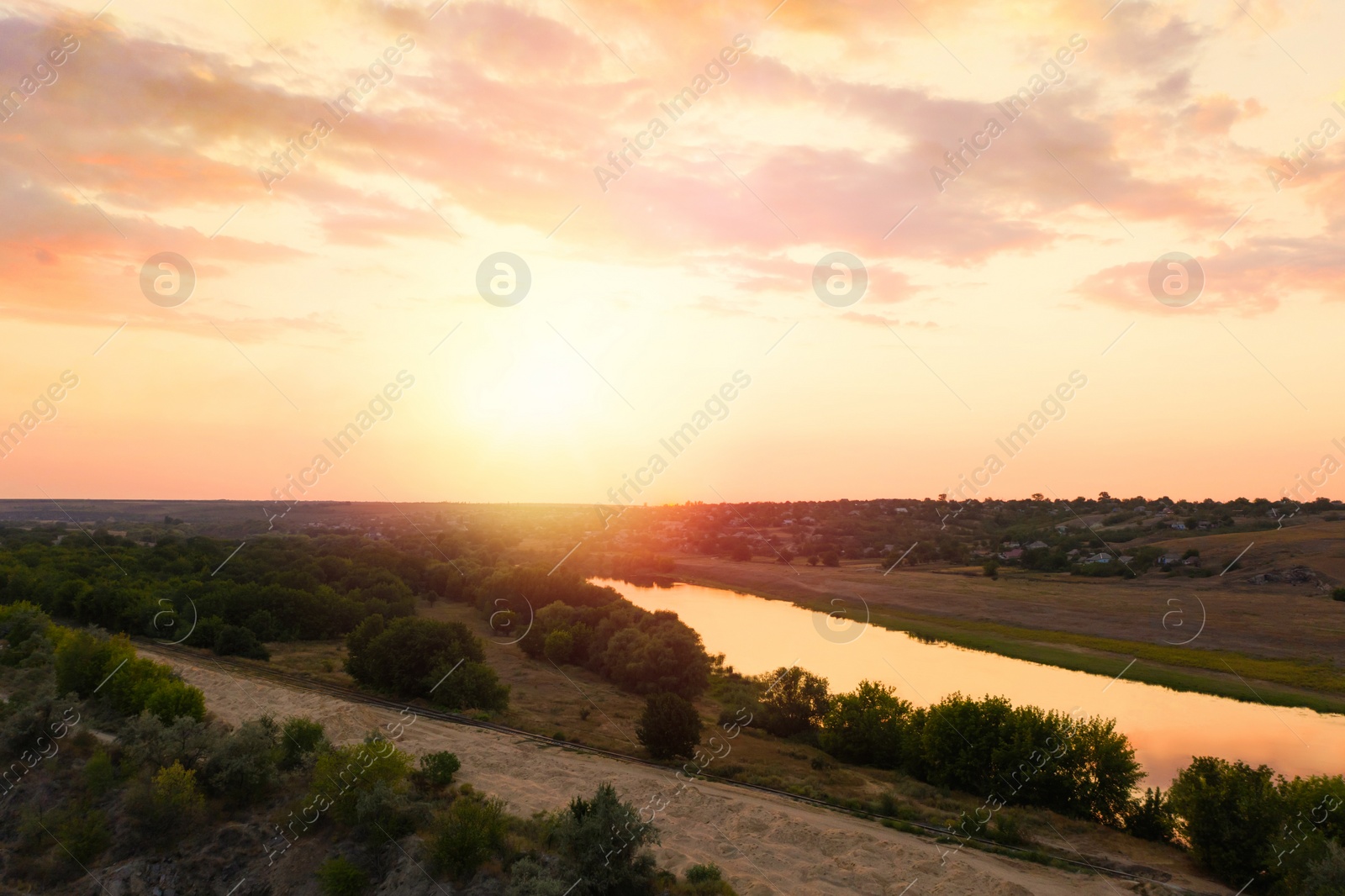 Image of Amazing cloudy sky over fields and river, aerial view. Sunset landscape