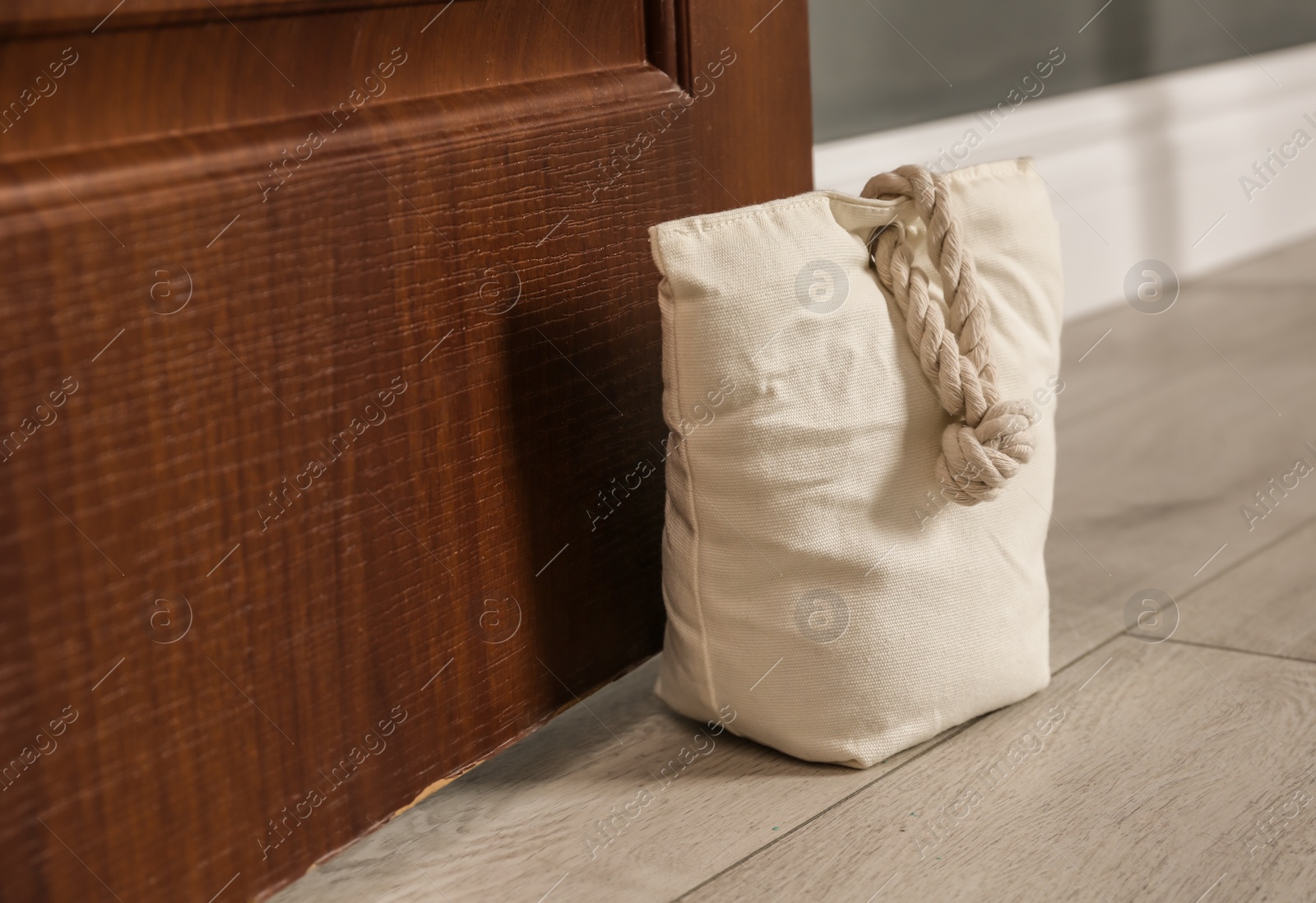 Stuffed bag holding wooden door at home Photo of Stuffed bag holding wooden door at home
