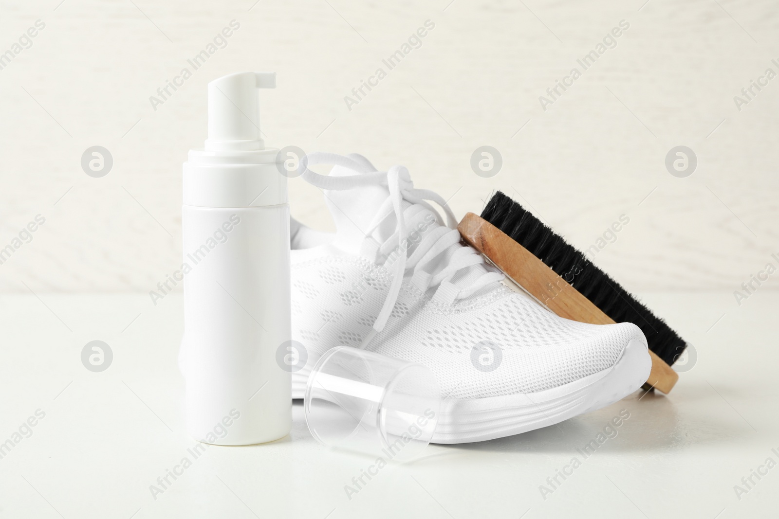 Photo of Stylish footwear and shoe care accessories on white background