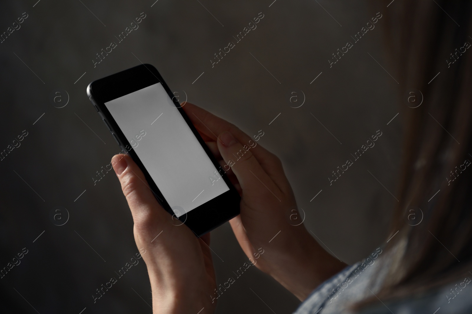 Photo of Woman using smartphone in dark room, closeup with space for text. Loneliness concept