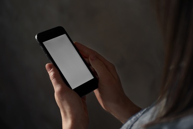 Photo of Woman using smartphone in dark room, closeup with space for text. Loneliness concept