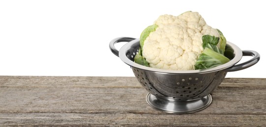 Photo of Metal colander with cauliflower on wooden table against white background, space for text