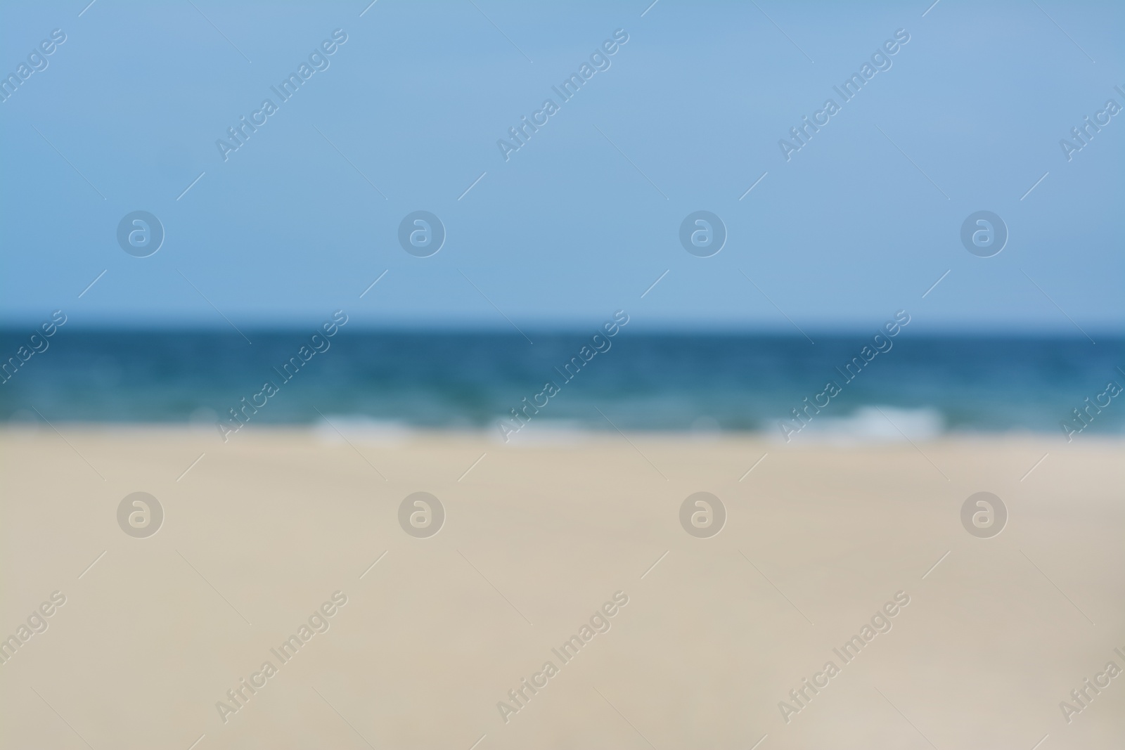 Photo of Blurred view of sandy beach and blue sea