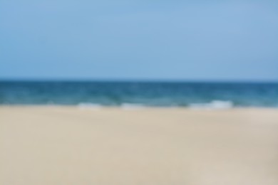 Blurred view of sandy beach and blue sea