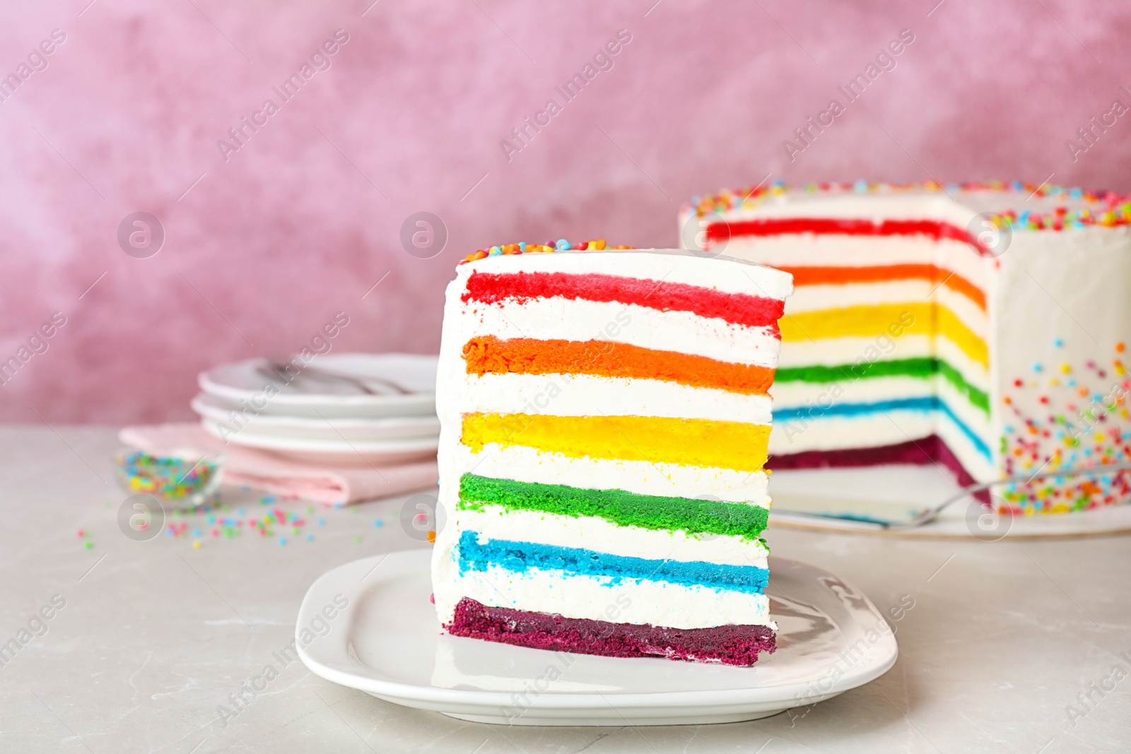 Photo of Delicious rainbow cake for party on table