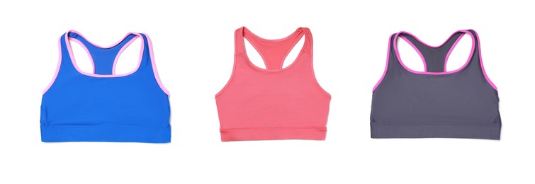 Comfortable sportswear. Set with different color sports bras on white background. top view