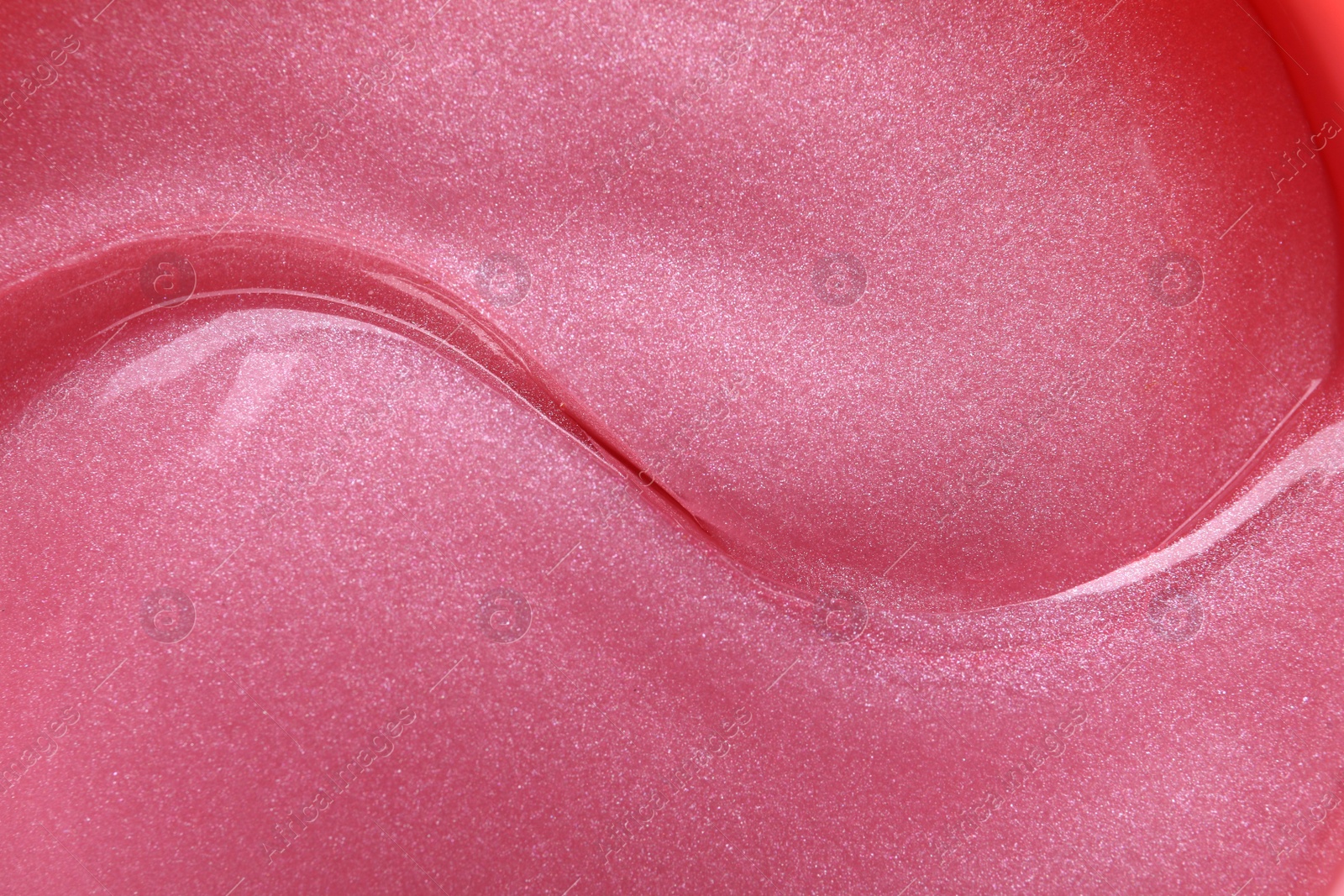 Photo of Shiny pink under eye patches as background, closeup. Cosmetic product