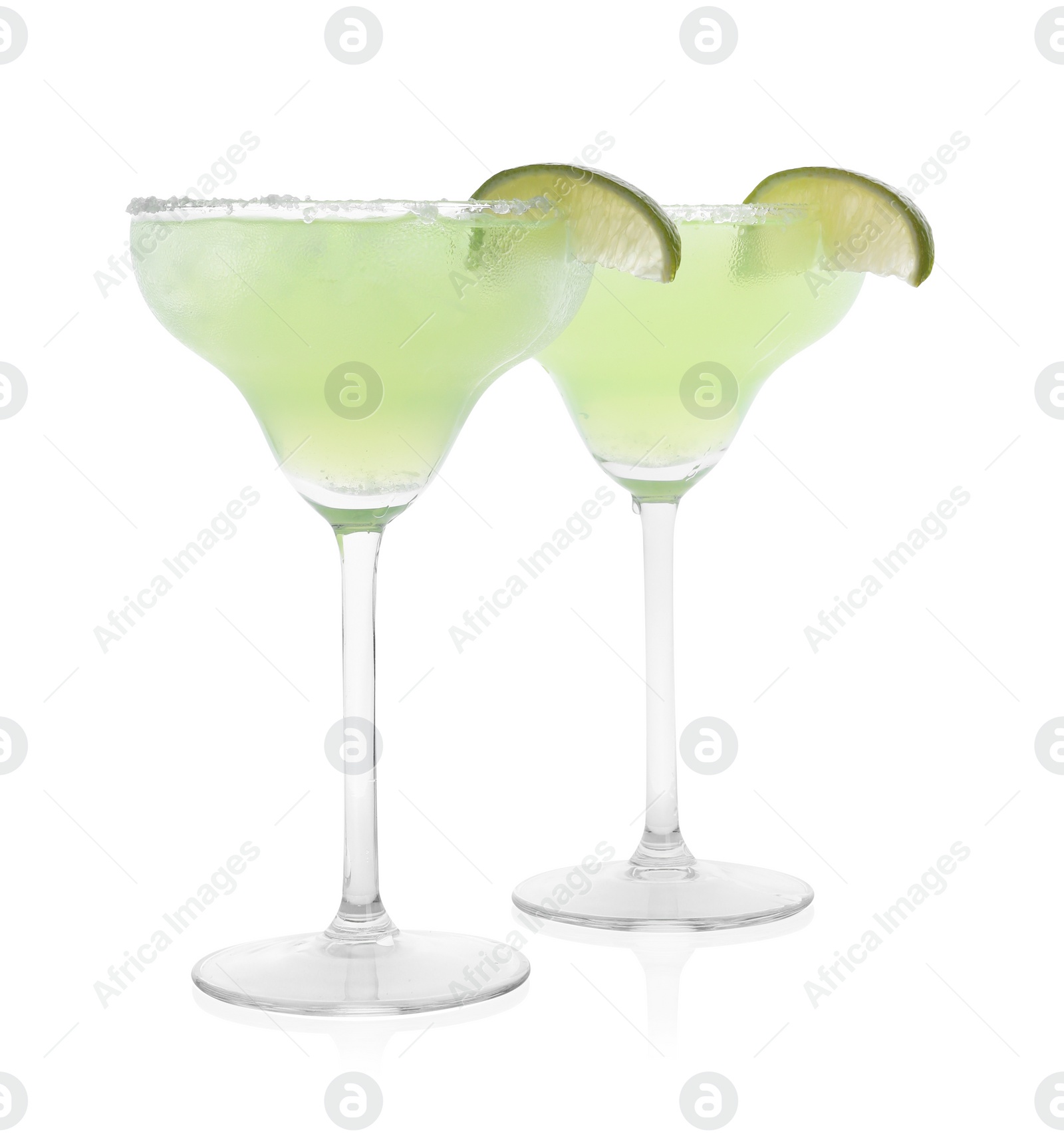 Photo of Delicious Margarita cocktail in glasses, salt and lime isolated on white