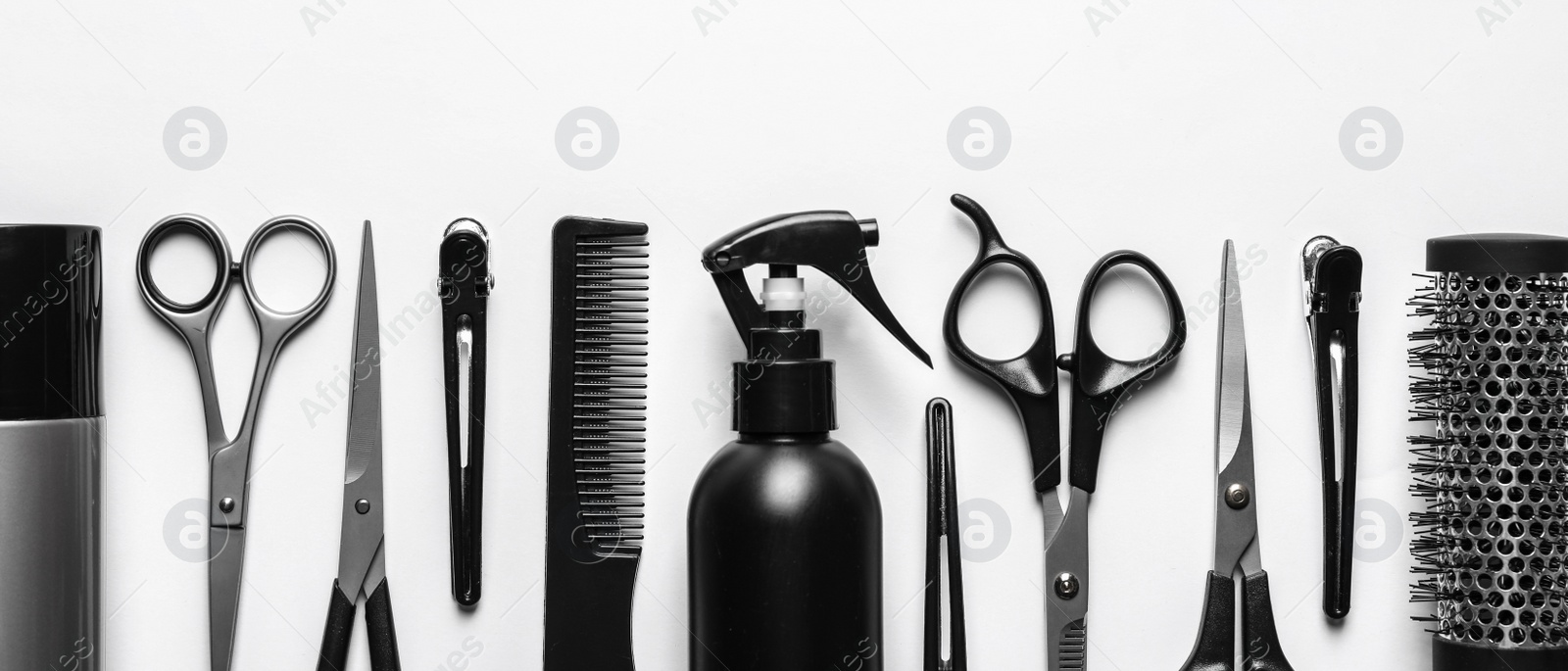 Image of Set with scissors and other hairdresser's accessories on white background, flat lay. Banner design