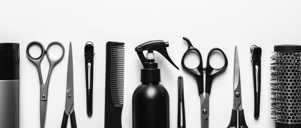 Image of Set with scissors and other hairdresser's accessories on white background, flat lay. Banner design