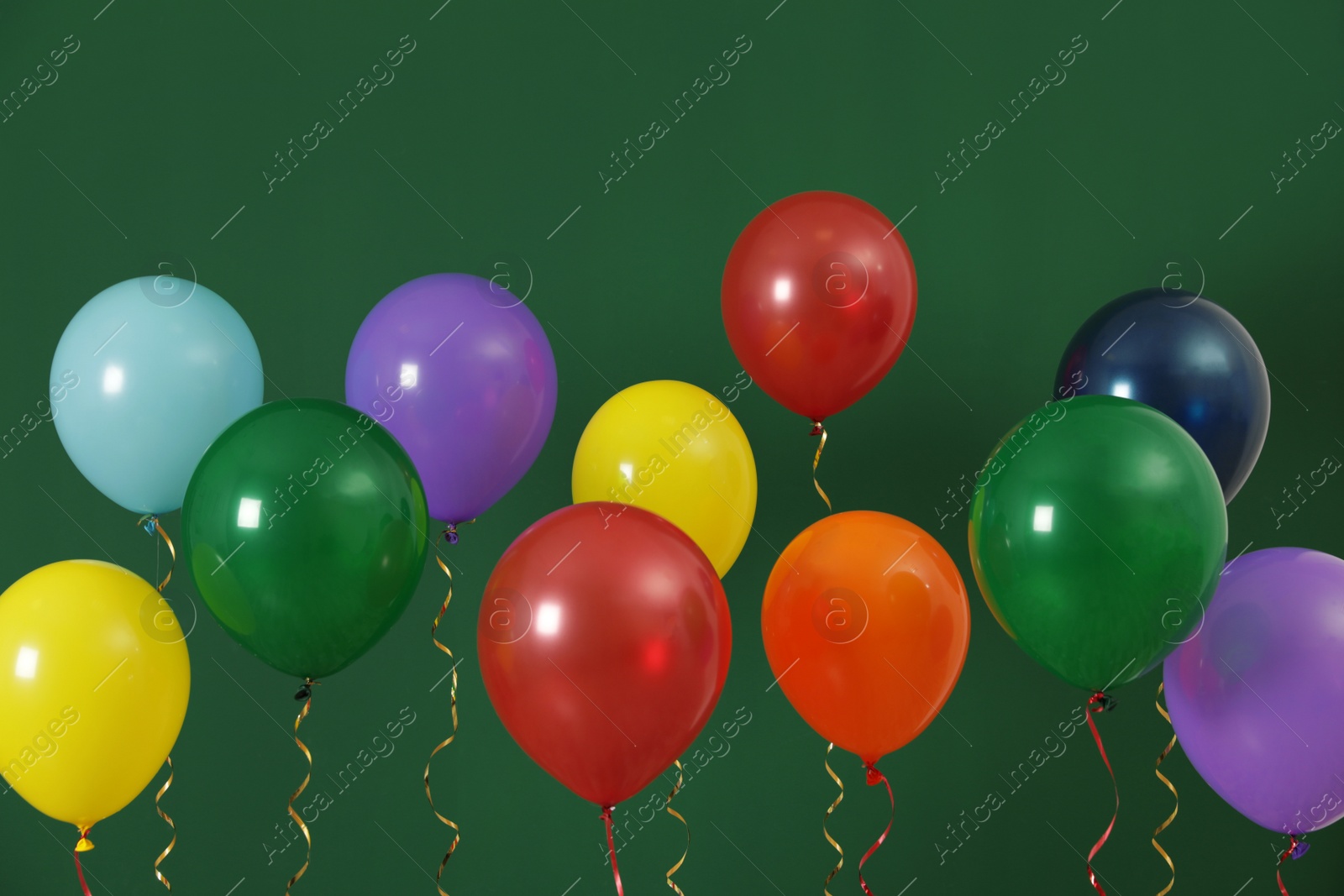 Photo of Bright balloons on color background. Celebration time