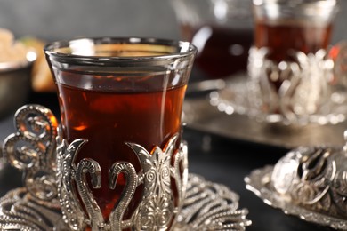 Photo of Traditional Turkish tea served in vintage tea set on table, closeup. Space for text