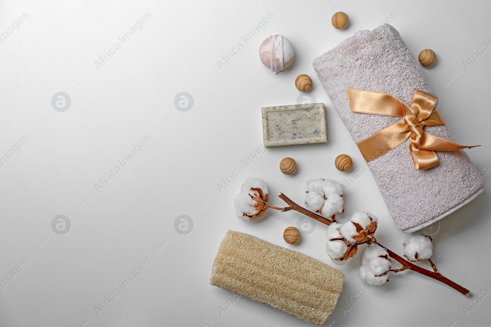 Photo of Composition with spa cosmetics, accessories and cotton flowers on white background