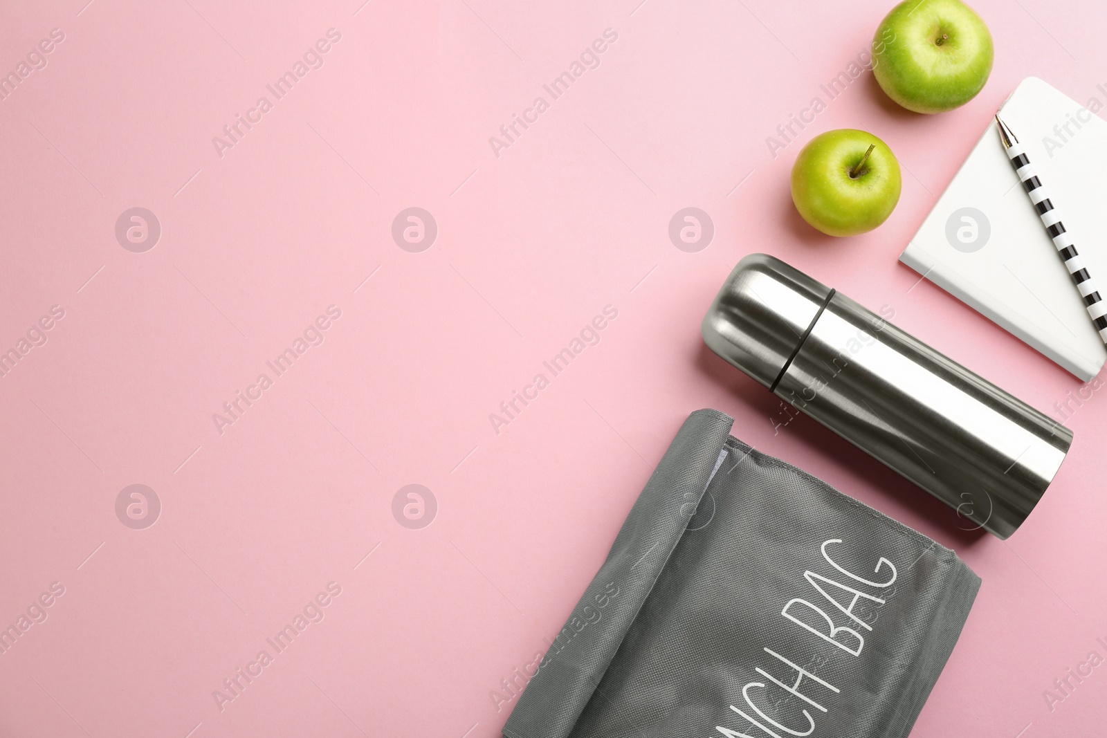 Photo of Flat lay composition with thermos on pink background. Space for text