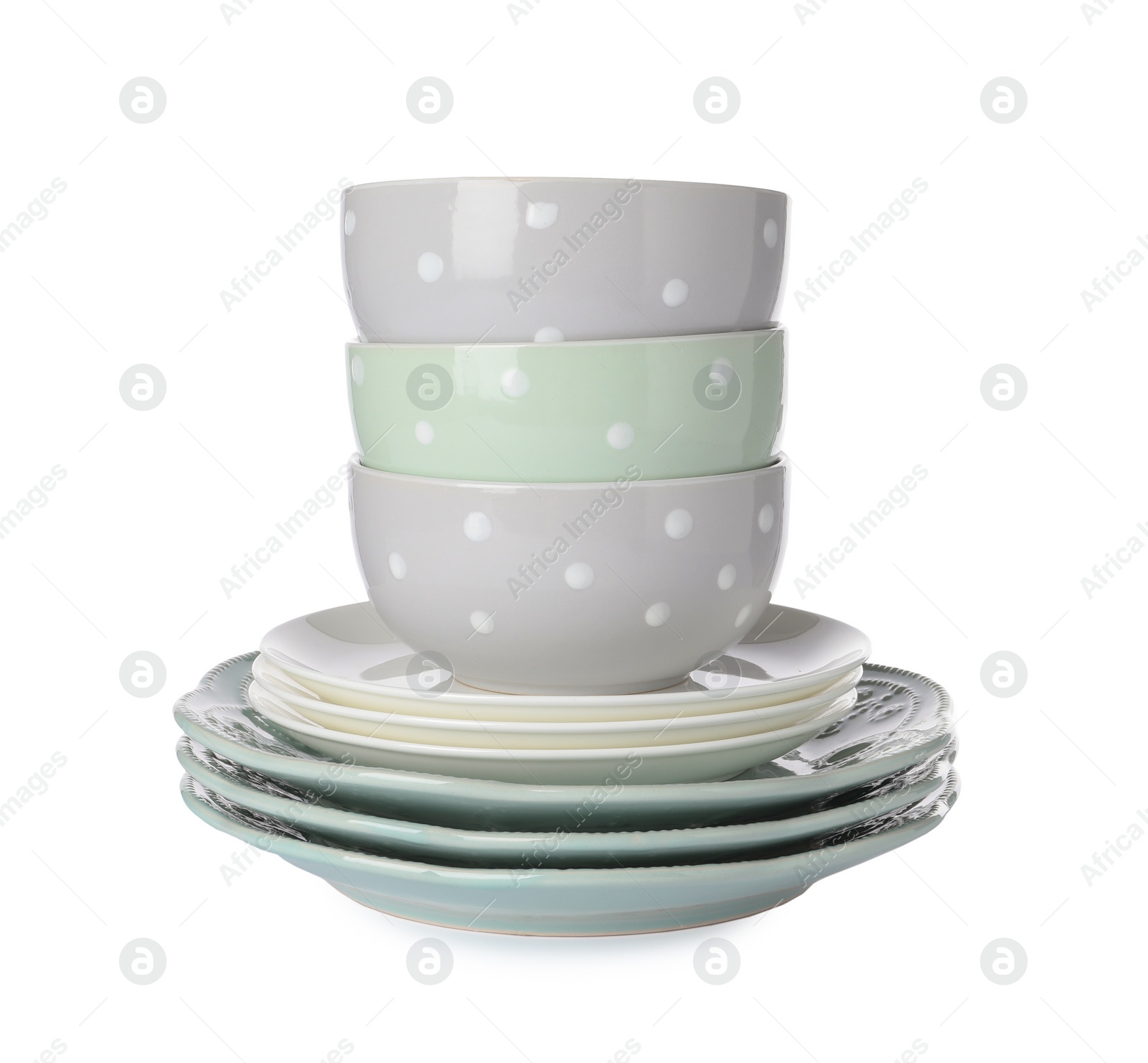 Photo of Beautiful ceramic plates and bowls isolated on white