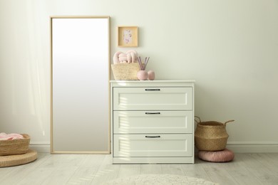 Modern room interior with white chest of drawers