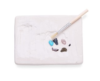Photo of Educational toy for motor skills development. Excavation kit (plaster, brush and gemstones) isolated on white, top view