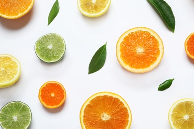 Photo of Different citrus fruits on white background, top view