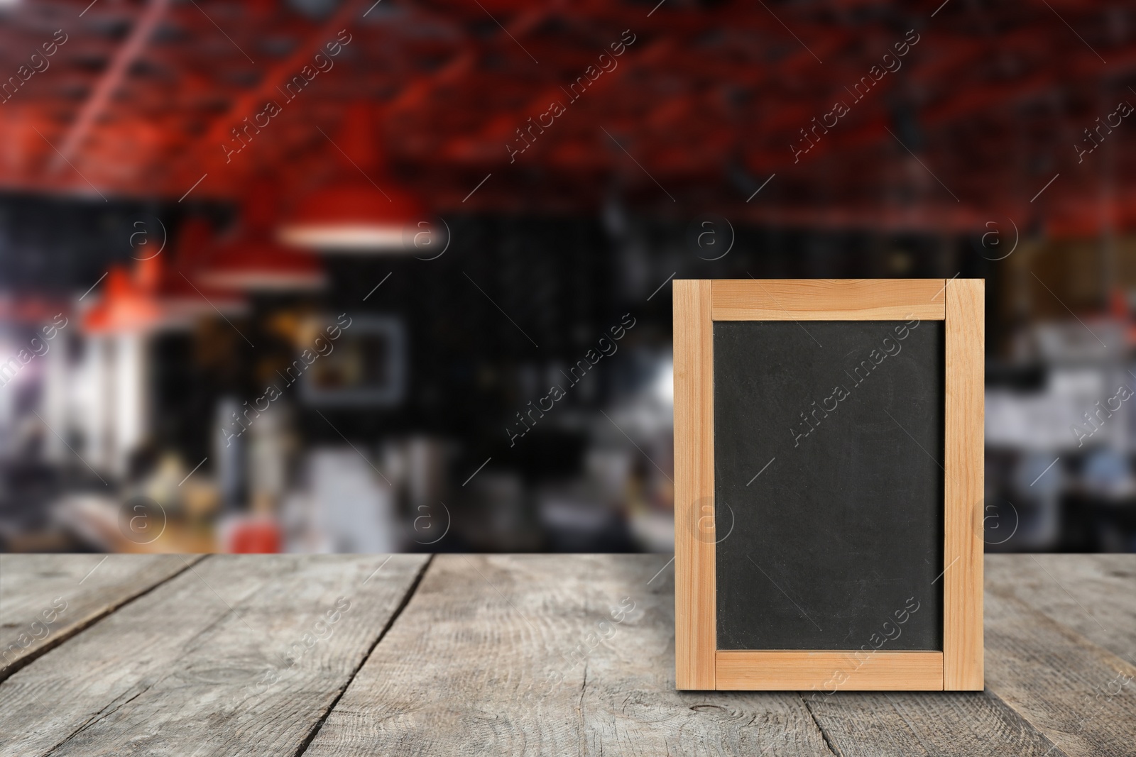 Image of Blank small blackboard on wooden table in cafe, mockup for menu design 