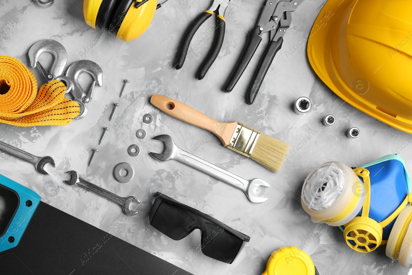 Photo of Flat lay composition with different construction tools on grey background