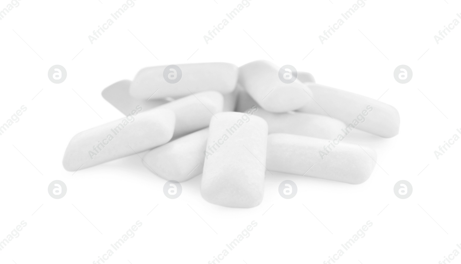 Photo of Heap of chewing gum pieces on white background