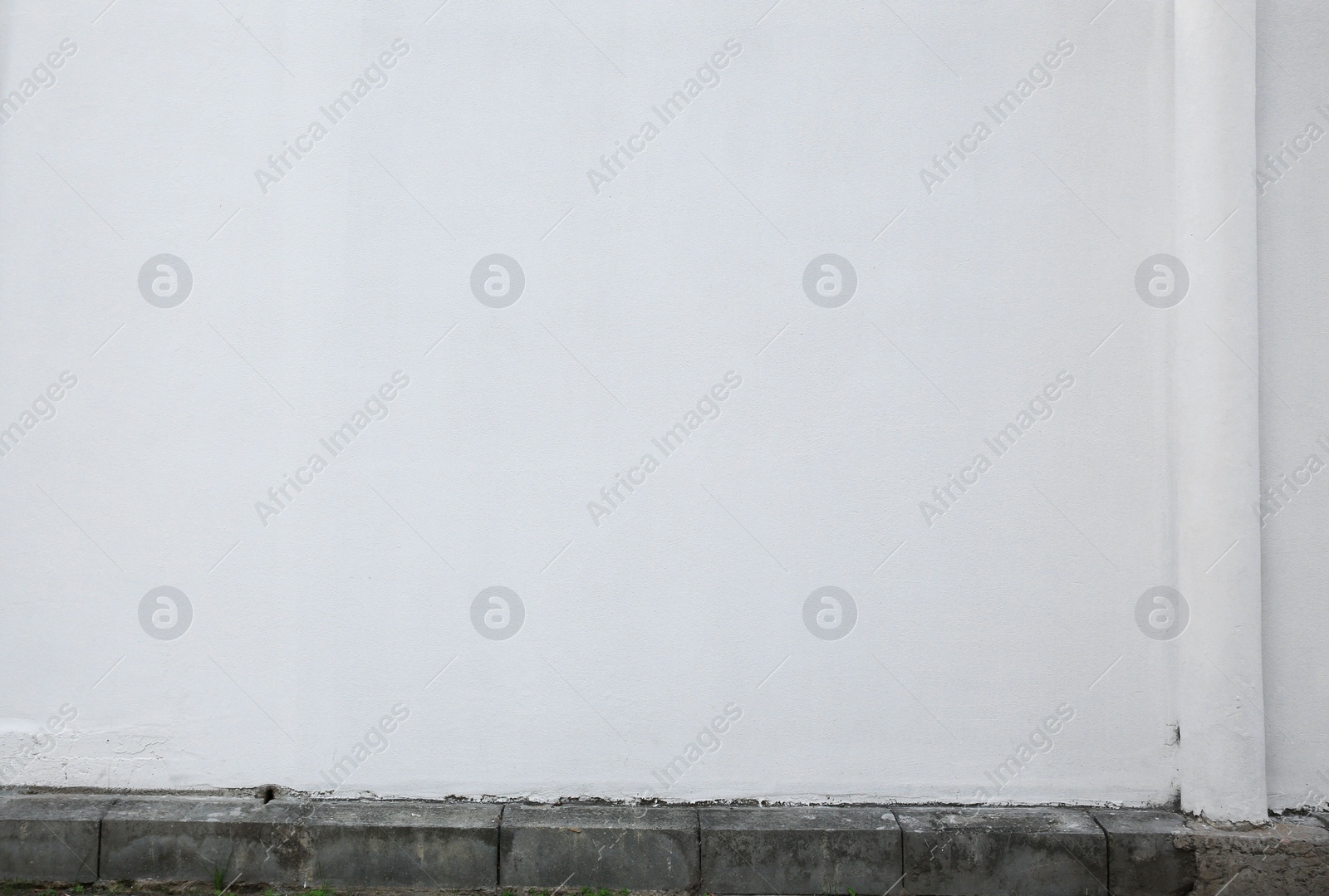 Photo of White stone wall of building outdoors. Exterior design