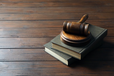 Photo of Judge gavel and books on wooden background. Law concept