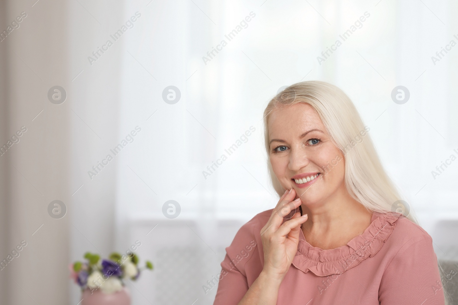 Photo of Portrait of beautiful older woman against blurred background with space for text