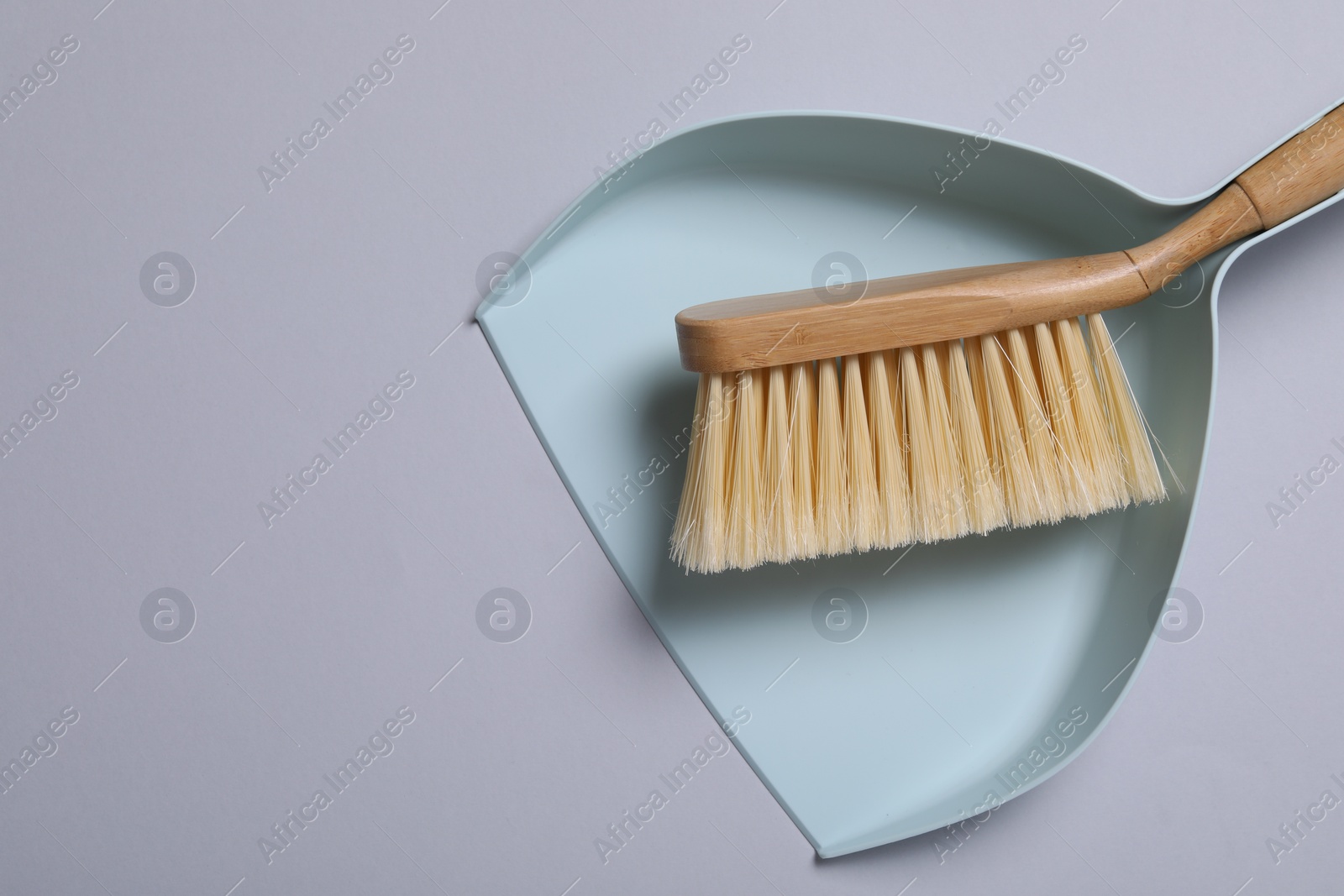 Photo of Cleaning brush and scoop on grey background, top view. Space for text