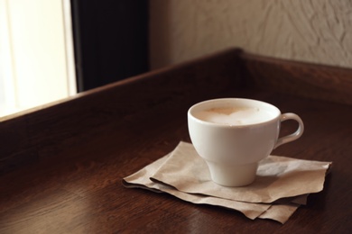 Cup of fresh aromatic coffee on table