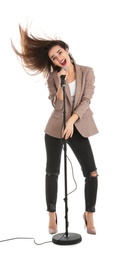 Young stylish woman singing in microphone on white background