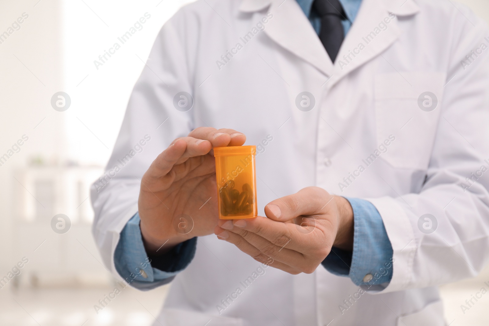 Photo of Professional pharmacist with pills in drugstore, closeup