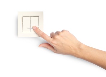 Photo of Woman pressing light switch on white background, closeup