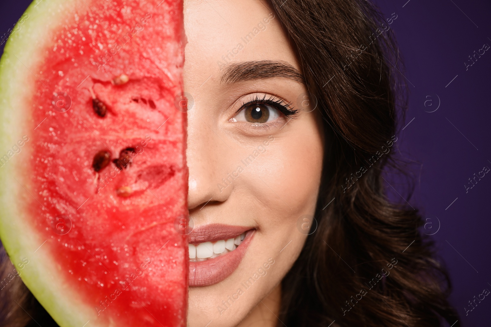 Photo of Beautiful young woman with watermelon on purple background, closeup