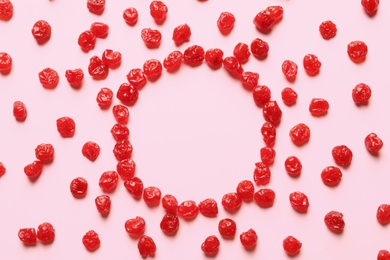 Photo of Frame of cherries on color background, top view with space for text. Dried fruit as healthy snack