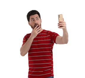 Photo of Emotional man taking selfie with smartphone on white background