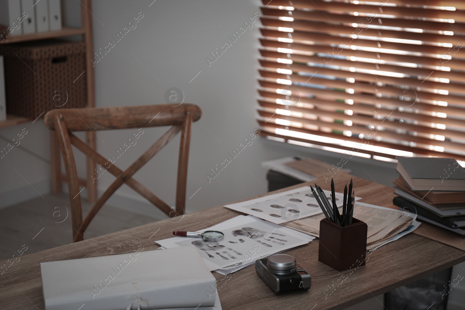 Photo of Fingerprints and papers on desk in office. Detective's workplace