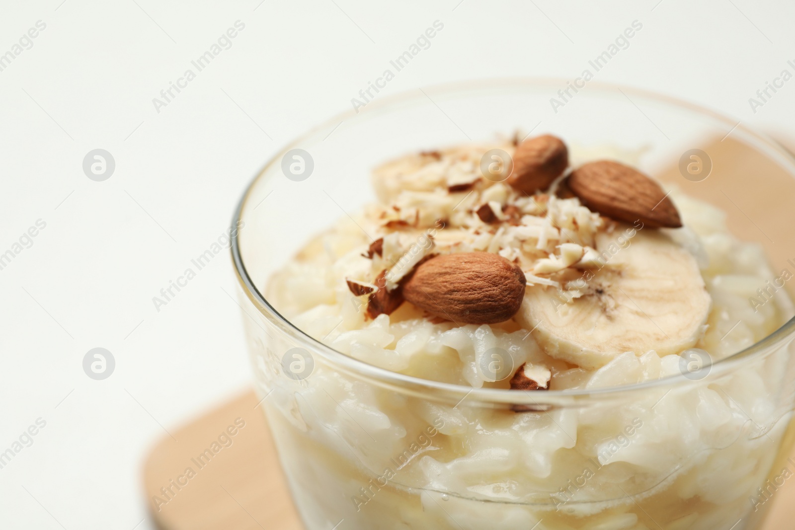 Photo of Delicious rice pudding with banana and almonds, closeup