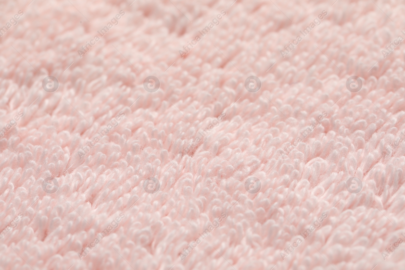 Photo of Texture of soft light pink fabric as background, closeup