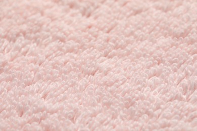 Texture of soft light pink fabric as background, closeup