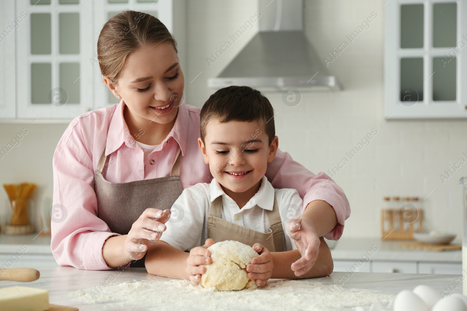 Photo of Mother and son cooking together in kitchen