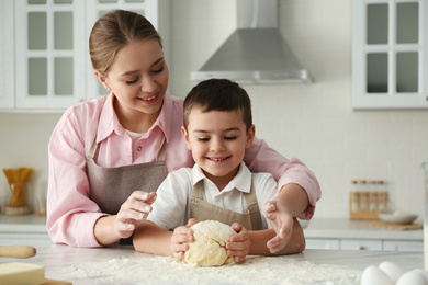 Mother and son cooking together in kitchen