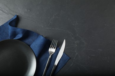 Stylish setting with elegant cutlery on grey textured table, flat lay. Space for text