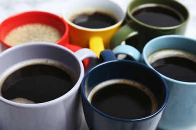 Photo of Many cups with tasty aromatic coffee, closeup