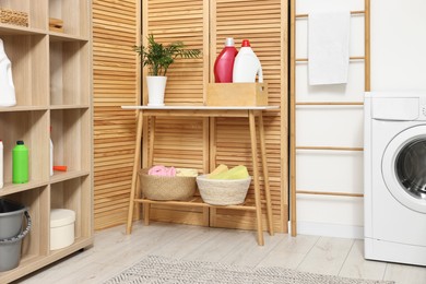 Photo of Laundry room interior with washing machine and furniture