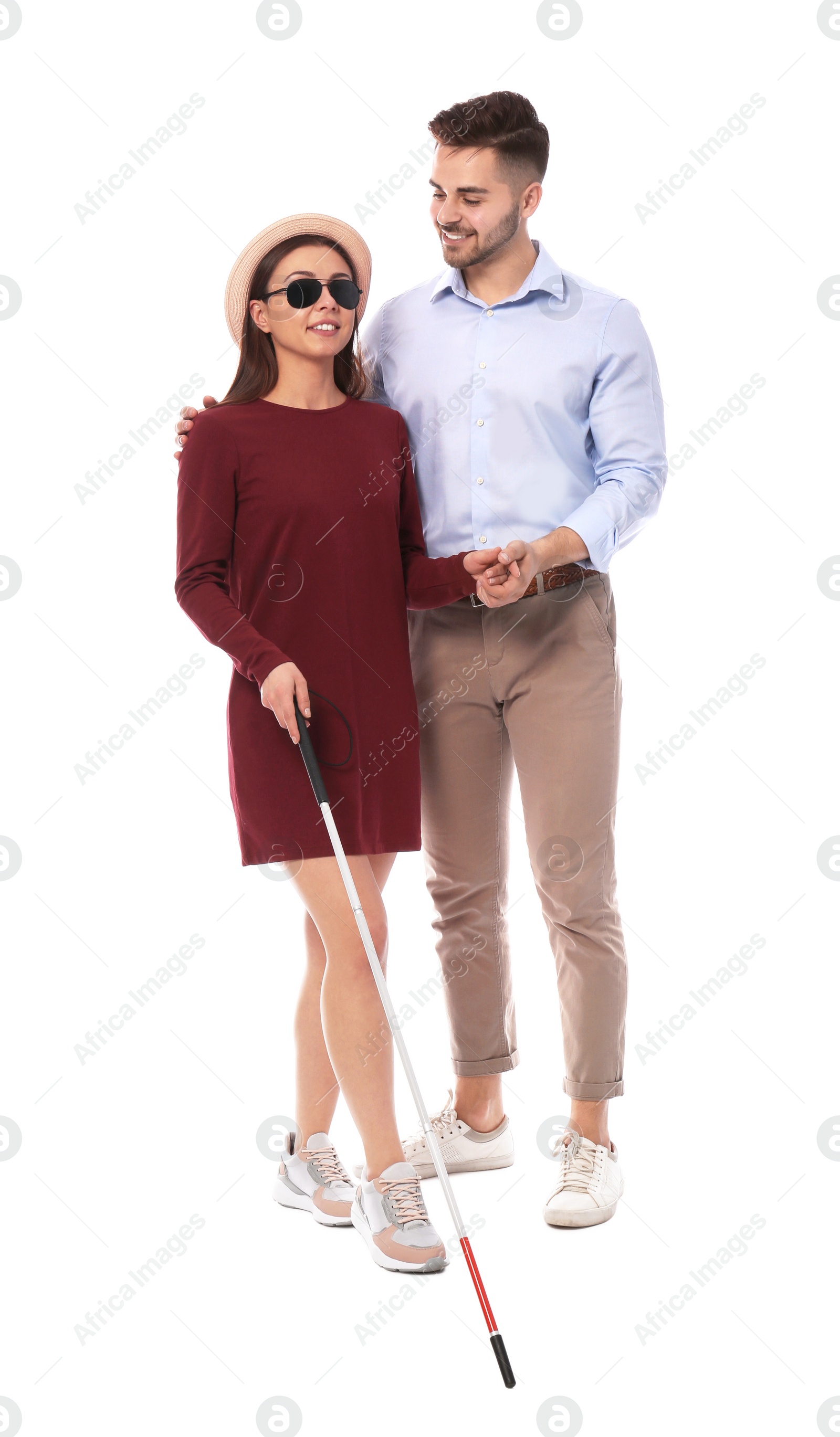 Photo of Young man helping blind person with long cane on white background
