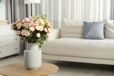 Beautiful bouquet of fresh flowers in vase on wooden coffee table indoors, space for text