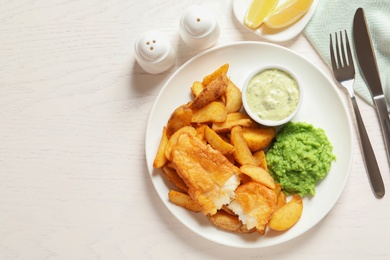 Photo of British Traditional Fish and potato chips on wooden background, flat lay. Space for text