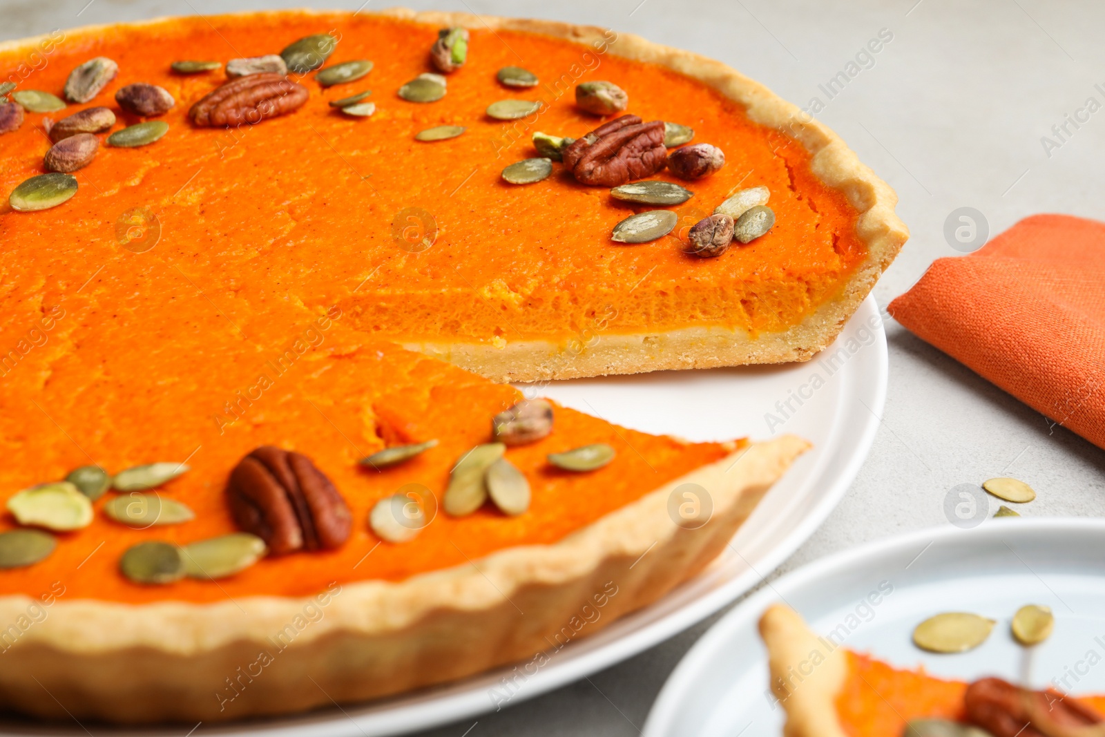 Photo of Delicious homemade pumpkin pie on light table, closeup